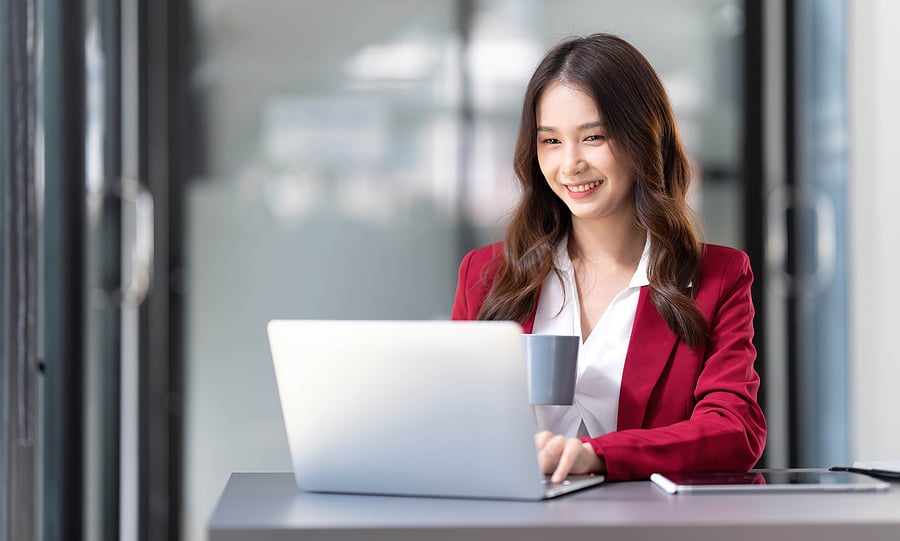 Woman filling out DNP program applications online at home