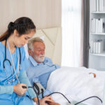 Cardiology nurse practitioner checking patient's blood pressure