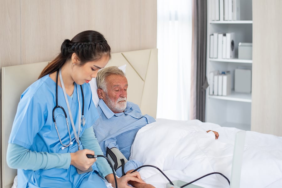 Cardiology nurse practitioner checking patient's blood pressure