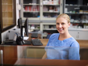 Nurse practitioner in a non-clinical role at desk with computer