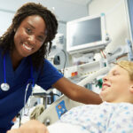 Nurse practitioner interacting with young male patient in the ER