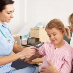 Family Nurse Practitioner giving a child a shot during clinical rotations