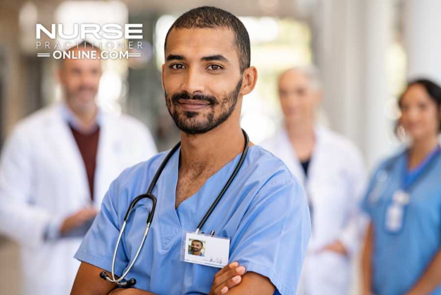 An emergency nurse stands in the foreground with additional medical staff in the background.