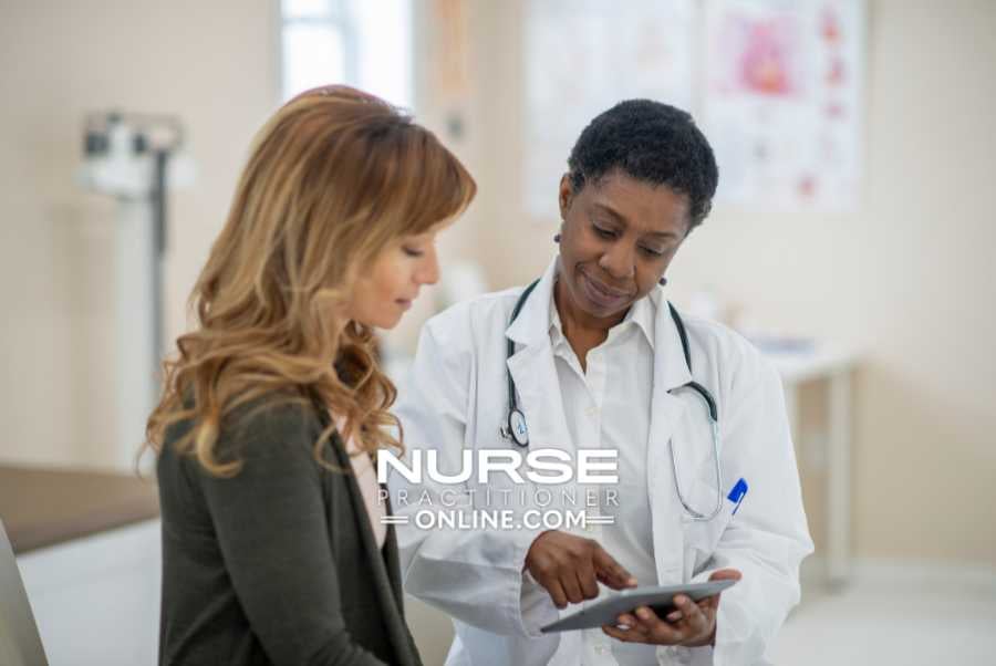 A nurse practitioner meets with a patient in a hospital.