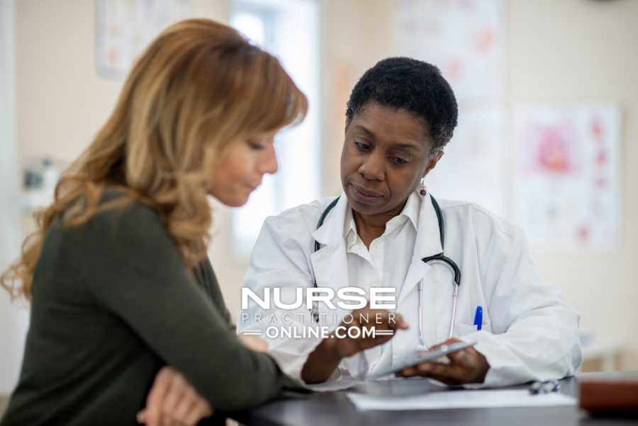A nurse practitioner meets with a patient at a breast center.
