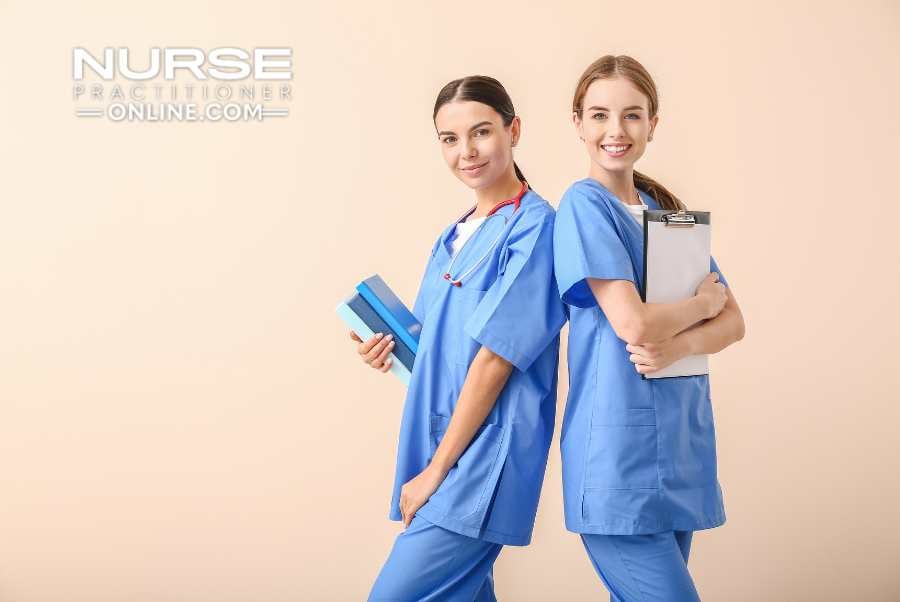 Two nurse practitioners stand back to back while holding charts and files.
