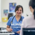 A nurse practitioner checks in with a colleague at a desk in a hospital.