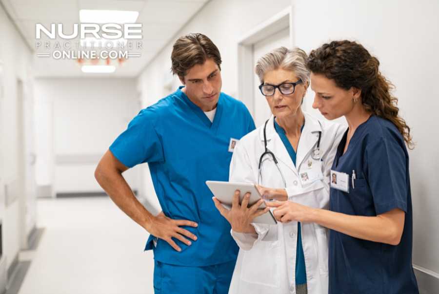 Two nurse practitioner residents consult with a doctor about a patient's chart.