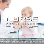 A pediatric nurse practitioner examines a young patient who is sitting on a table in an exam room.